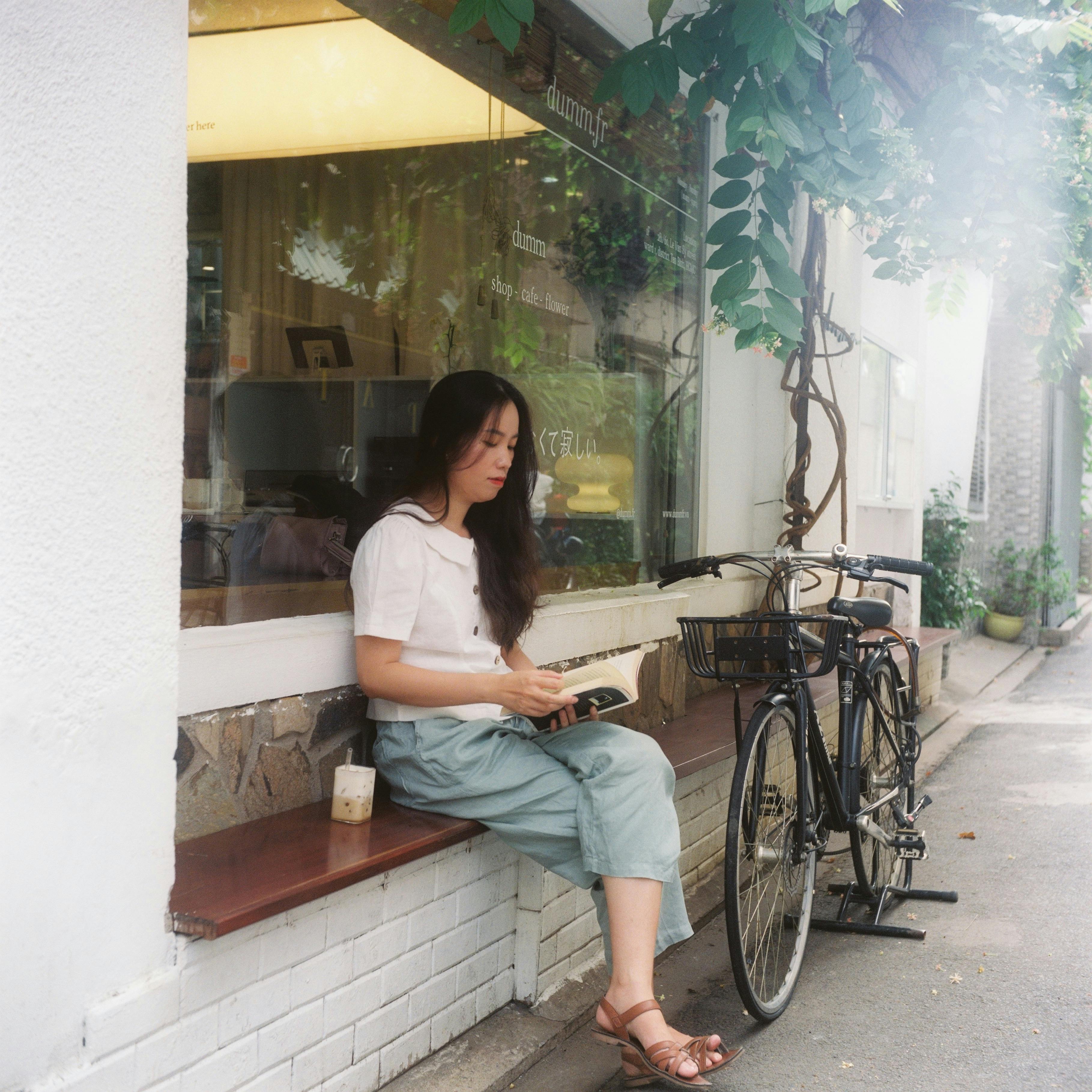 solo traveller journaling in a warm old-town cafe with summer light